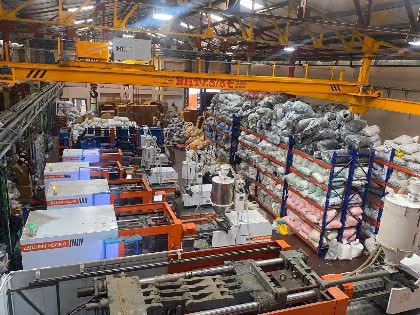 Injection molding machines running on the Trumould floor in Delhi, with raw material racked alongside