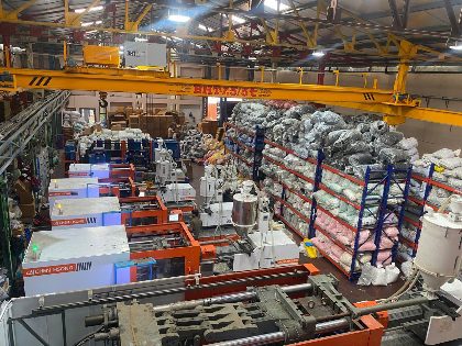 Injection molding machines running on the Trumould floor in Delhi, with raw material racked alongside